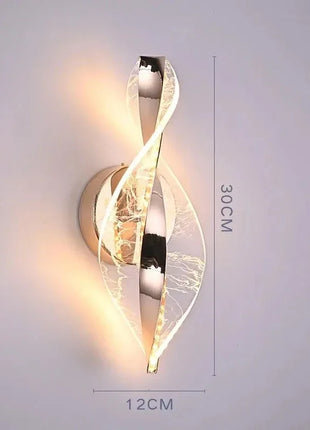 Aplique de parede LED dourado em espiral, placa circular e medidas 12x30 cm.