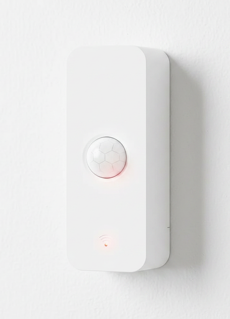 Sensor de movimento PIR branco com lente hexagonal e luzes indicadoras.